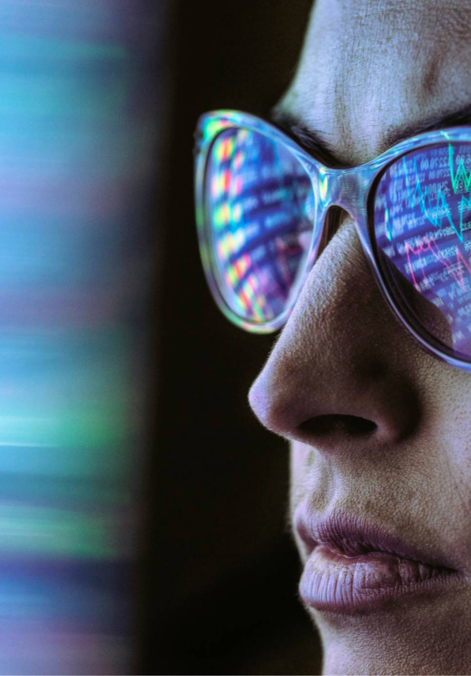  Close-up of a person wearing sunglasses, reflecting charts and stock movements.